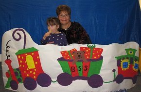 A family posing with the BSS Christmas train